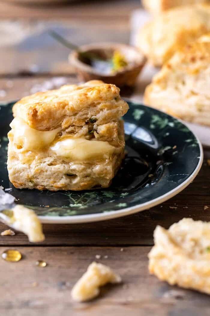 Layered Jalapeño Cheddar Biscuits with Salted Honey Butter | halfbakedharvest.com side angled photo of Layered Jalapeño Cheddar Biscuits on plate with Salted Honey Butter