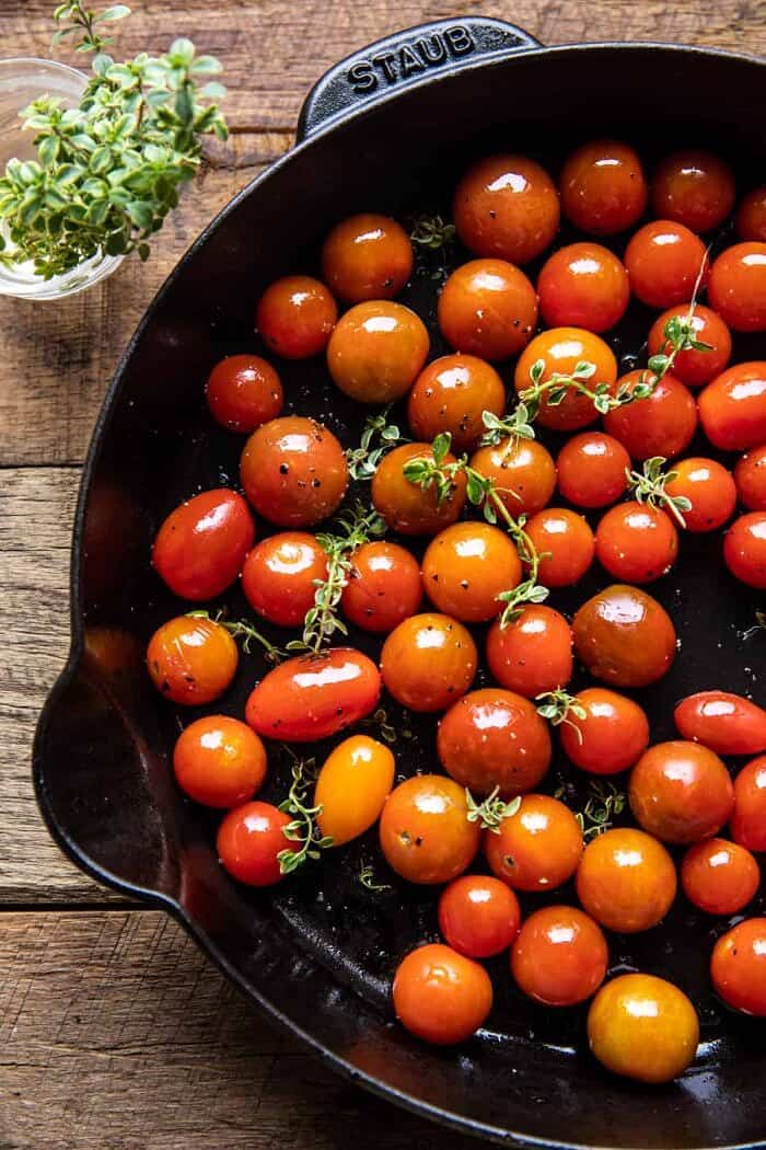 20 Minute Florentine Butter Chicken with Burst Cherry Tomatoes | halfbakedharvest.com overhead photo of Burst Cherry Tomatoes in skillet