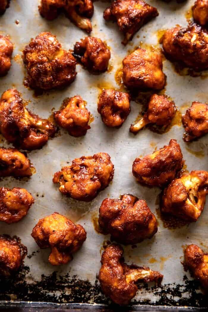 Crispy Beer Battered BBQ Cauliflower Nuggets | halfbakedharvest.com overhead photo of Crispy Beer Battered BBQ Cauliflower Nuggets on baking sheet after baking