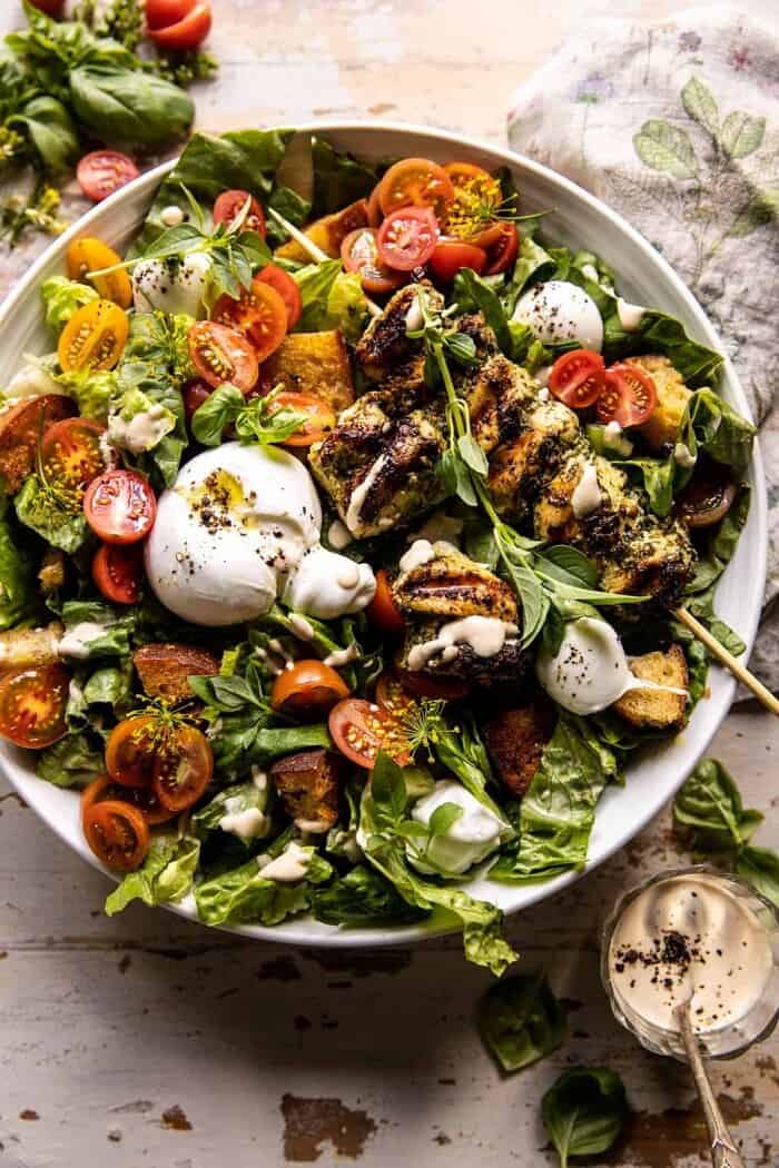 overhead photo of Pesto Chicken Caesar Salad with Tomatoes and Burrata 