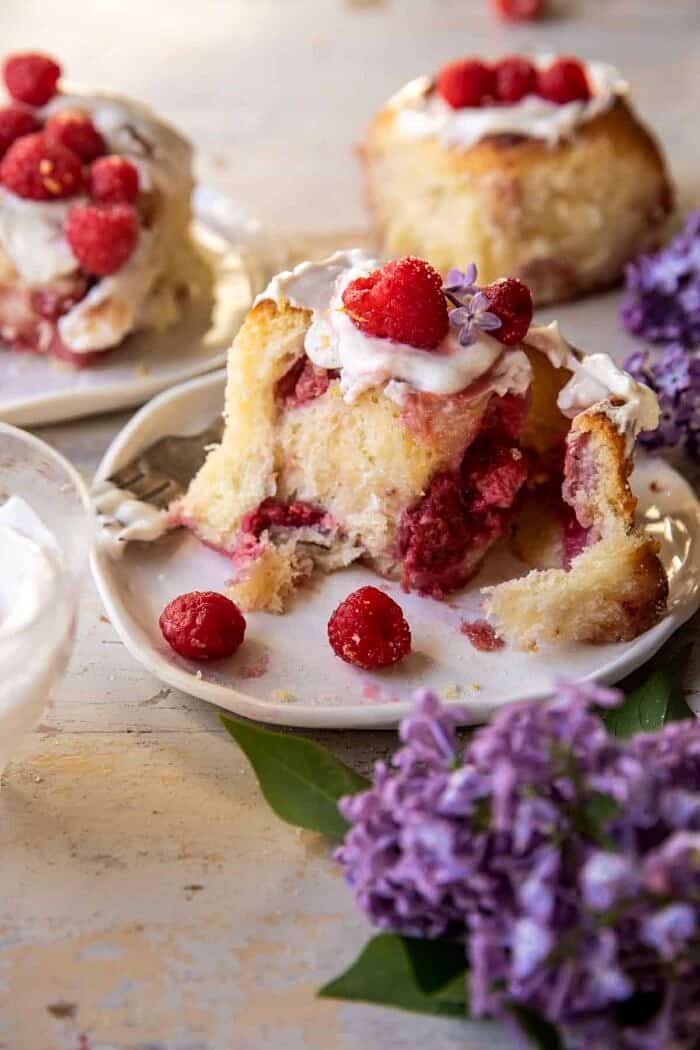 Raspberry Lemon Brioche Rolls with Whipped Ricotta Cream | halfbakedharvest.com side angle close up photo of Raspberry Lemon Brioche Roll on plate with Whipped Ricotta Cream