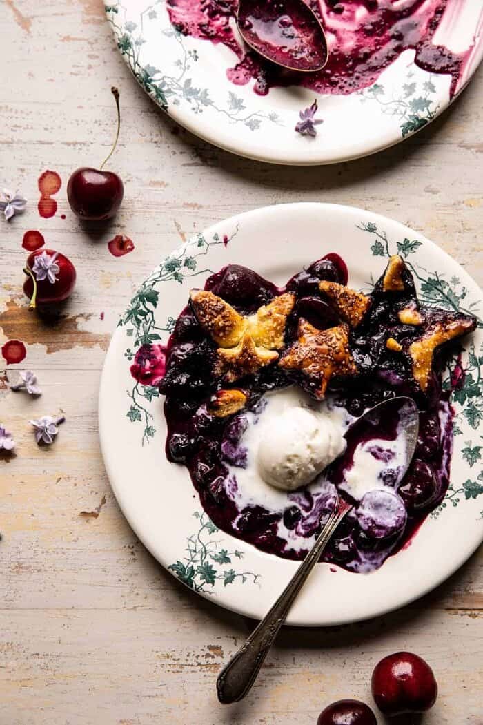 Skillet Blueberry Bourbon Pandowdy | halfbakedharvest.com overhead photo of Skillet Blueberry Bourbon Pandowdy on plate with ice cream and spoon