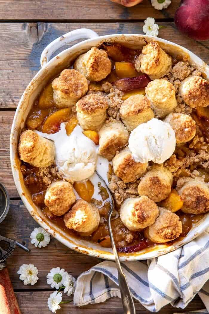 Southern Double Crusted Cinnamon Sugar Peach Cobbler | halfbakedharvest.com overhead close up photo of Southern Double Crusted Cinnamon Sugar Peach Cobbler with ice cream on top