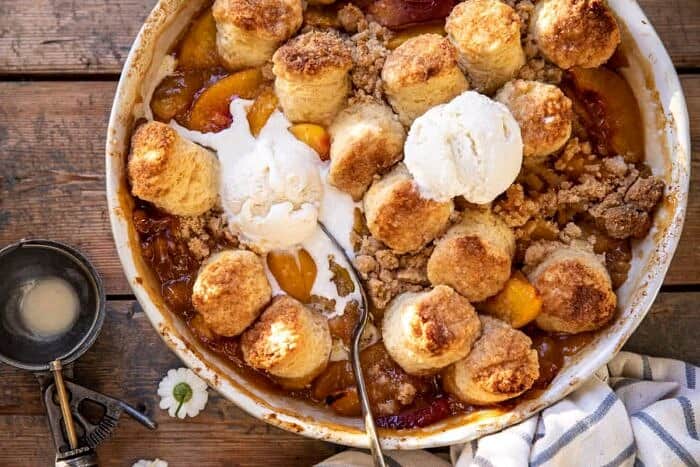 Southern Double Crusted Cinnamon Sugar Peach Cobbler | halfbakedharvest.com overhead horizontal photo of Southern Double Crusted Cinnamon Sugar Peach Cobbler with ice cream on top