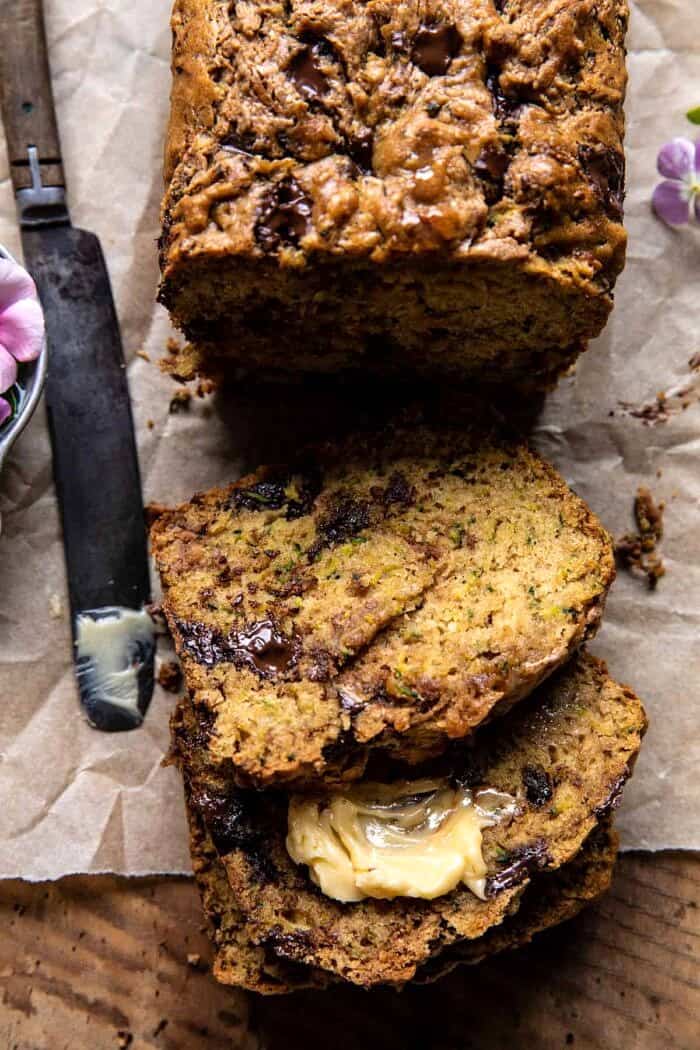 Chocolate Chunk Almond Butter Zucchini Bread | halfbakedharvest.com overhead photo of Chocolate Chunk Almond Butter Zucchini Bread with 3 slices of bread cut