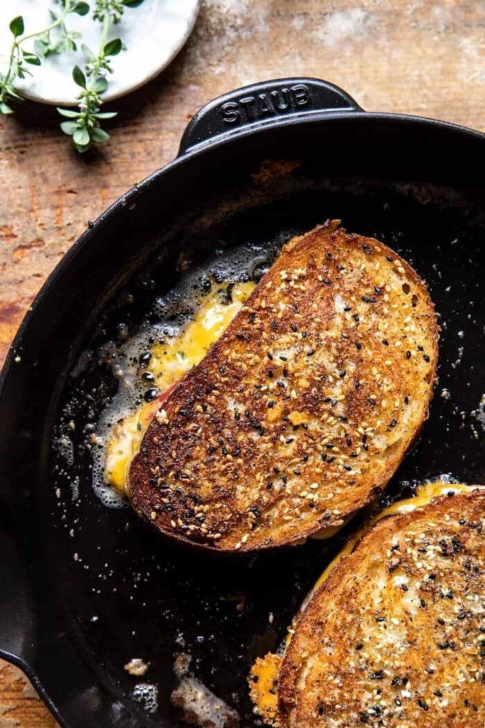 Everything Cheddar Tomato Bacon Grilled Cheese | halfbakedharvest.com overhead photo of Everything Cheddar Tomato Bacon Grilled Cheese in skillet