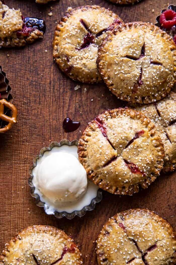 overhead photo Jammy Raspberry Cream Pretzel Hand Pies with ice cream
