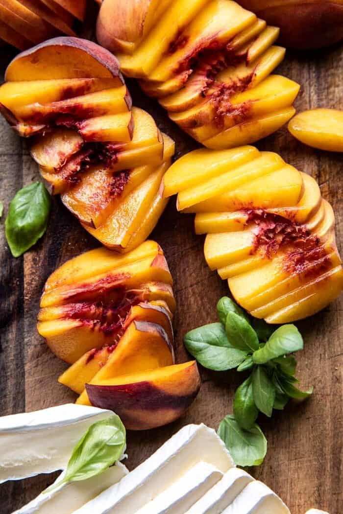 Peach Brie Pastry Tarts with Peppered Rosemary Honey | halfbakedharvest.com raw peaches on cutting board
