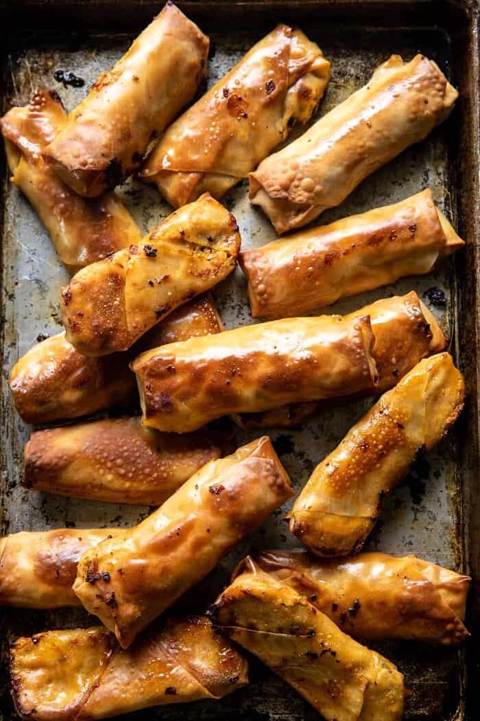 Baked Buffalo Chicken Egg Rolls with Cilantro Lime Ranch | halfbakedharvest.com overhead photo of Baked Buffalo Chicken Egg Rolls after baking on baking sheet