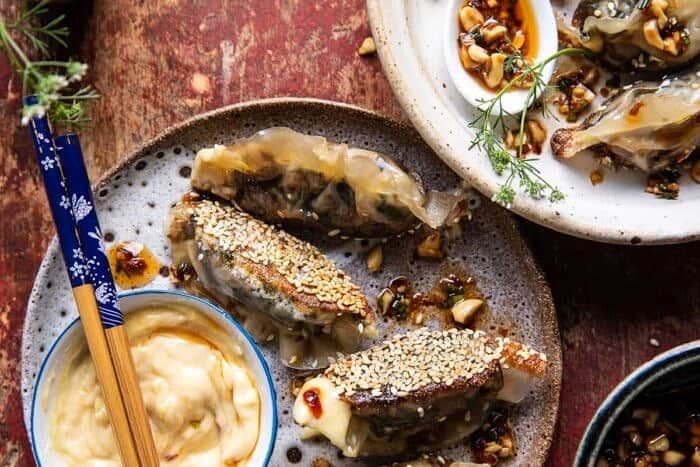 Crispy Sesame Ginger Potstickers with Chive Chili Sauce | halfbakedharvest.com overhead horizontal photo of Crispy Sesame Ginger Potstickers with Chive Chili Sauce
