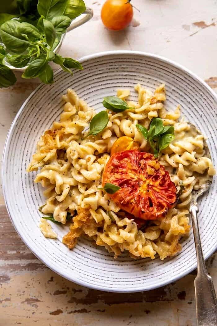One Pot 4 Cheese Caprese Mac and Cheese | halfbakedharvest.com overhead photo of One Pot 4 Cheese Caprese Mac and Cheese on serving plate with spoon