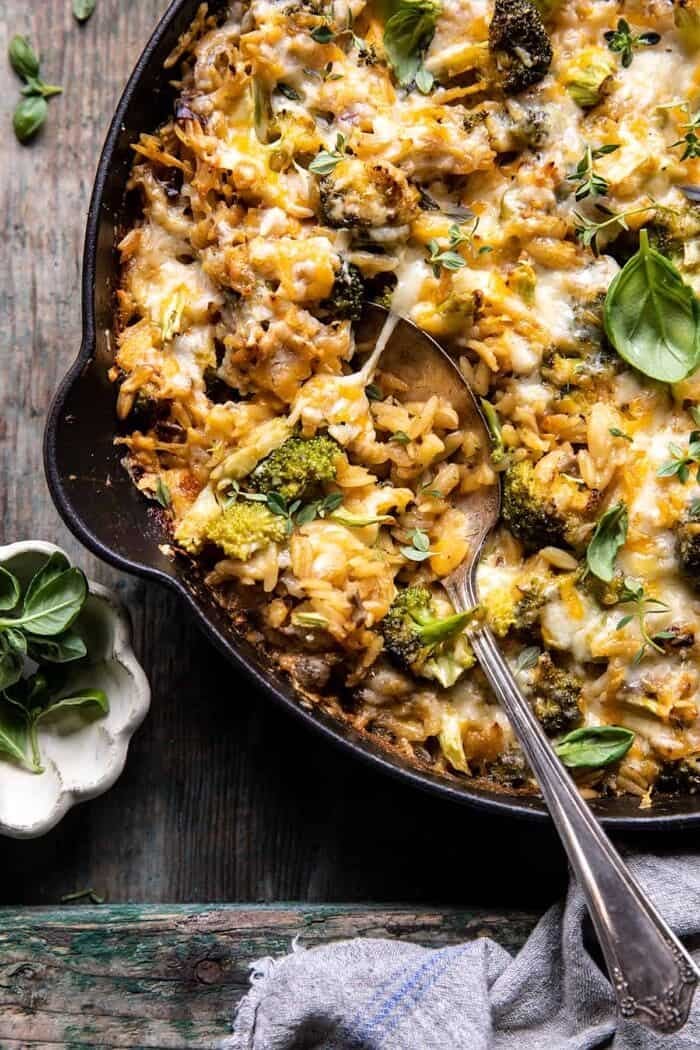 One Skillet Cheesy Broccoli Cheddar Orzo Bake | halfbakedharvest.com overhead close up photo of One Skillet Cheesy Broccoli Cheddar Orzo Bake with spoon in skillet