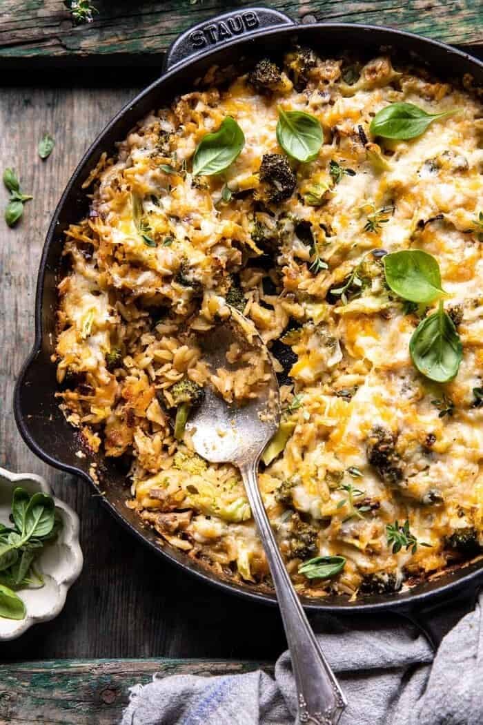One Skillet Cheesy Broccoli Cheddar Orzo Bake | halfbakedharvest.com overhead photo of One Skillet Cheesy Broccoli Cheddar Orzo Bake with spoon in skillet