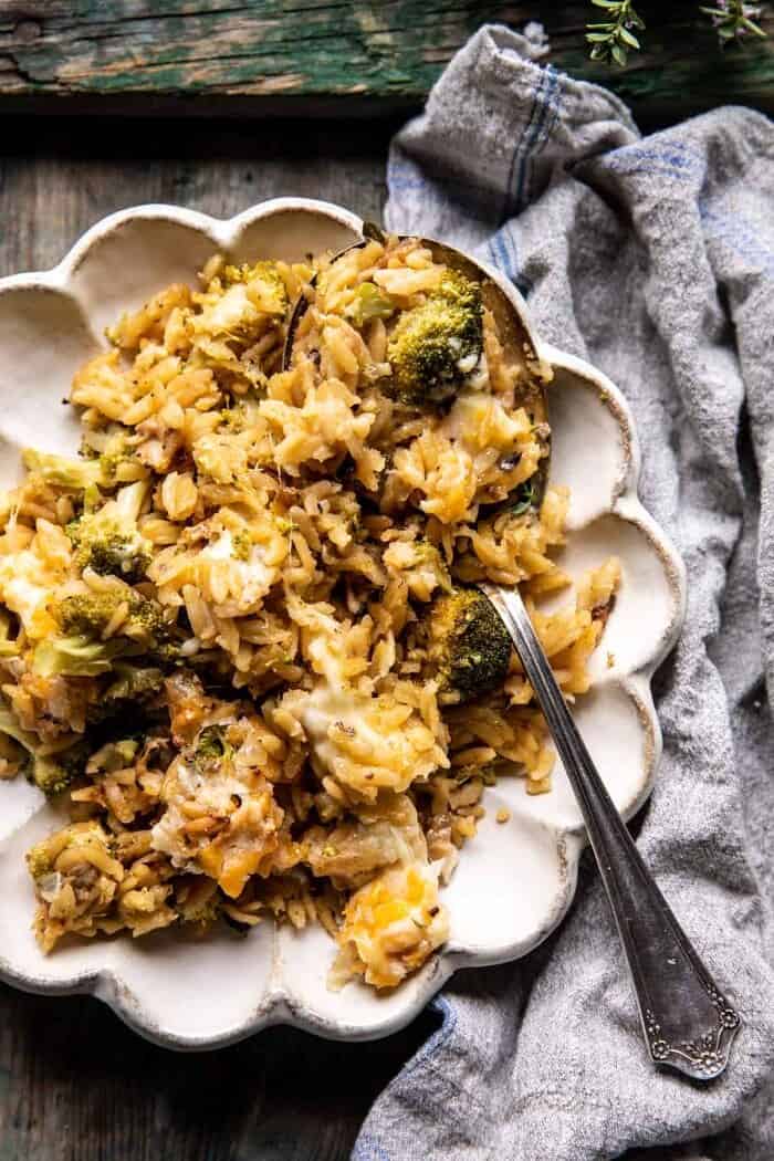One Skillet Cheesy Broccoli Cheddar Orzo Bake | halfbakedharvest.com overhead photo of One Skillet Cheesy Broccoli Cheddar Orzo Bake on dinner plate with spoon