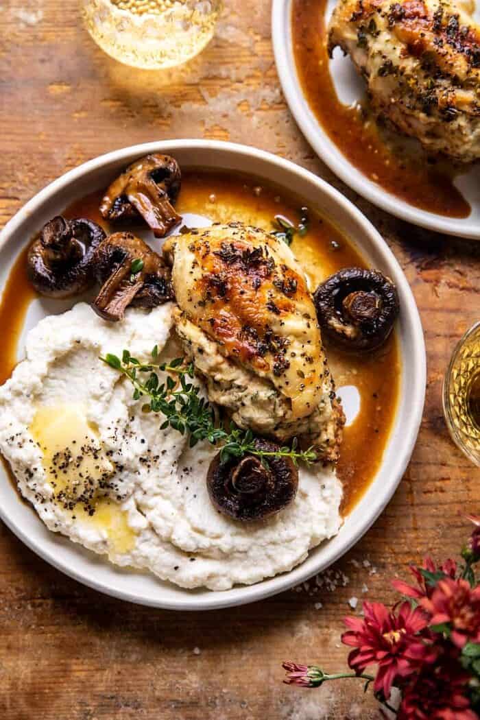 overhead photo of Herbed Ricotta Stuffed Chicken In White Wine Pan Sauce on a plate with mashed cauliflower 