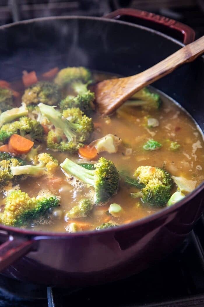 One Pot Broccoli Cheddar and Dumplings | halfbakedharvest.com prep photo of broccoli simmering in soup