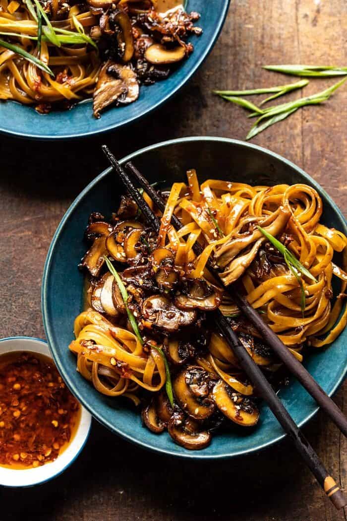 overhead photo of 30 Minute Saucy Ginger Sesame Noodles with Caramelized Mushrooms with chopsticks in bowl 