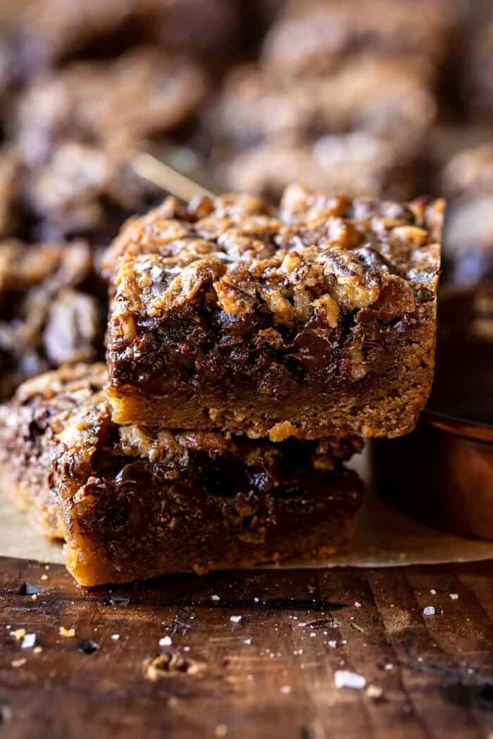 Brown Sugar Maple Chocolate Pecan Pie Bars | halfbakedharvest.com side angled photo of Brown Sugar Maple Chocolate Pecan Pie Bars with 2 bars stacked on top of each other