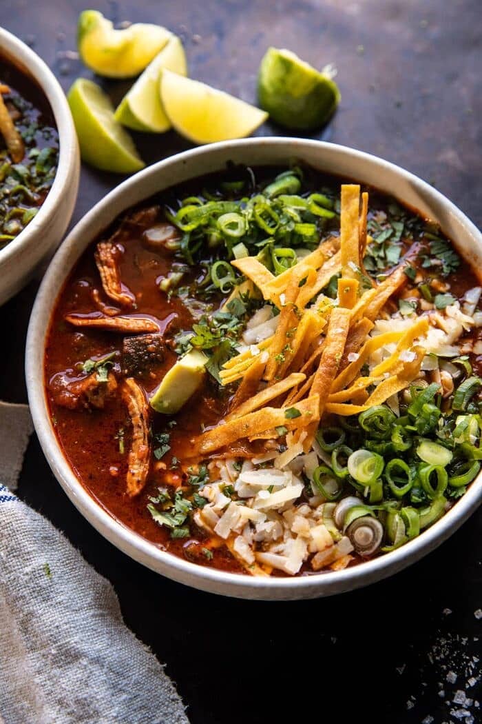 Slow Cooker Chipotle Chicken Tortilla Soup with Salty Lime Chips | halfbakedharvest.com side angled photo of Slow Cooker Chipotle Chicken Tortilla Soup with Salty Lime Chips