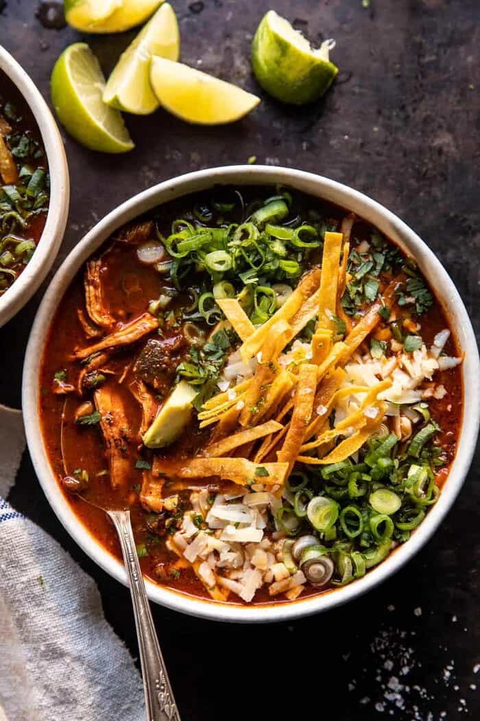 Slow Cooker Chipotle Chicken Tortilla Soup with Salty Lime Chips | halfbakedharvest.com overhead photo of Slow Cooker Chipotle Chicken Tortilla Soup with Salty Lime Chips with spoon in bowl