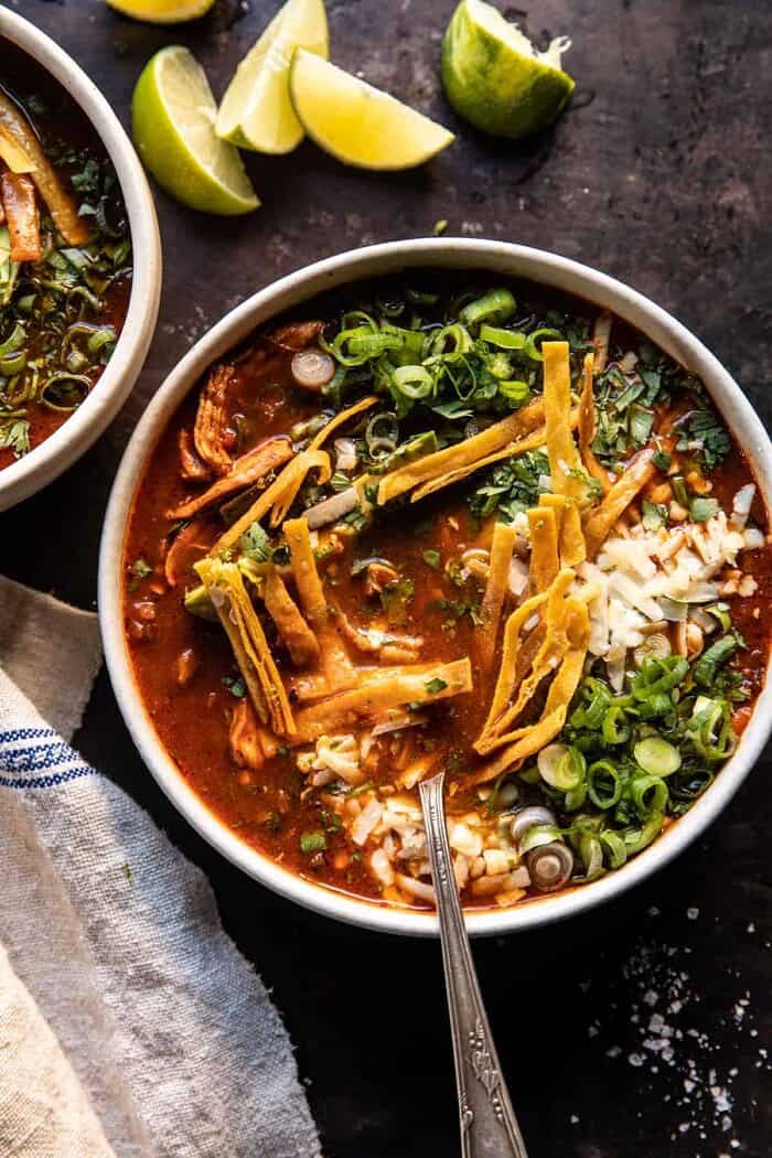 Slow Cooker Chipotle Chicken Tortilla Soup with Salty Lime Chips | halfbakedharvest.com overhead photo of Slow Cooker Chipotle Chicken Tortilla Soup with Salty Lime Chips with spoon in bowl