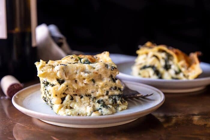 4 Cheese Sage Pesto Florentine Lasagna | halfbakedharvest.com side angled horizontal photo of 4 Cheese Sage Pesto Florentine Lasagna