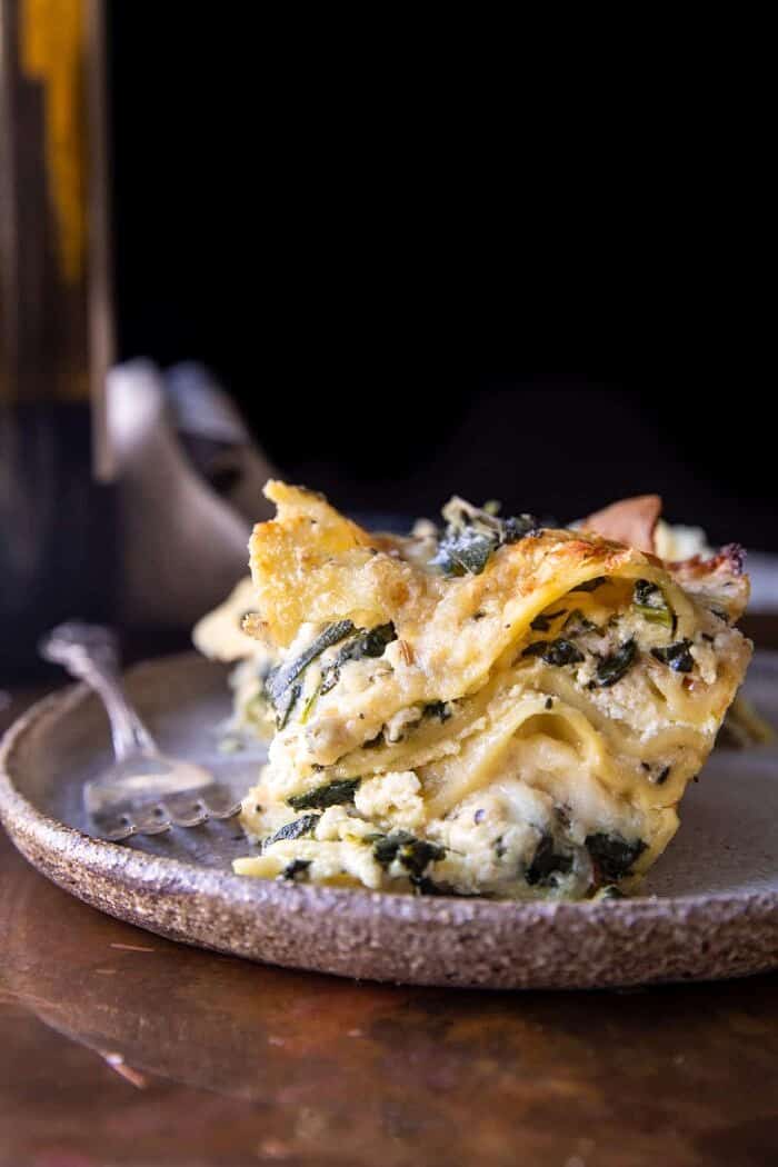 4 Cheese Sage Pesto Florentine Lasagna | halfbakedharvest.com side angled photo of 4 Cheese Sage Pesto Florentine Lasagna | halfbakedharvest.com