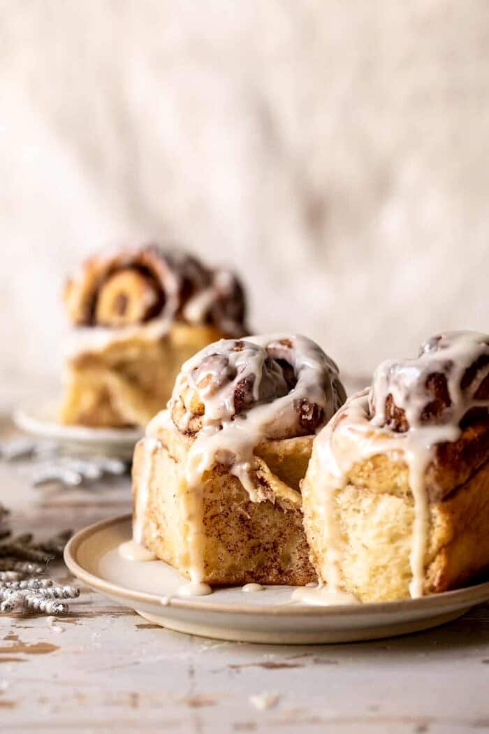 Easy Fluffy Eggnog Cinnamon Rolls | halfbakedharvest.com Easy Fluffy Eggnog Cinnamon Rolls on serving plates