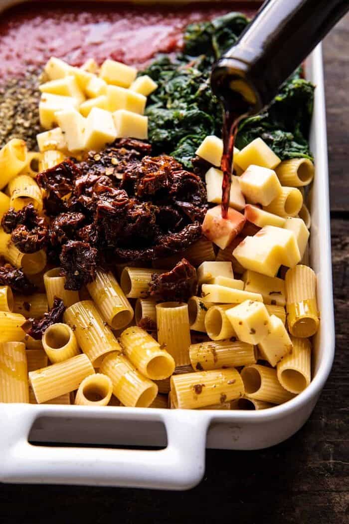 One Pan 4 Cheese Sun-Dried Tomato and Spinach Pasta Bake | halfbakedharvest.com side angled photo of One Pan 4 Cheese Sun-Dried Tomato and Spinach Pasta Bake before baking