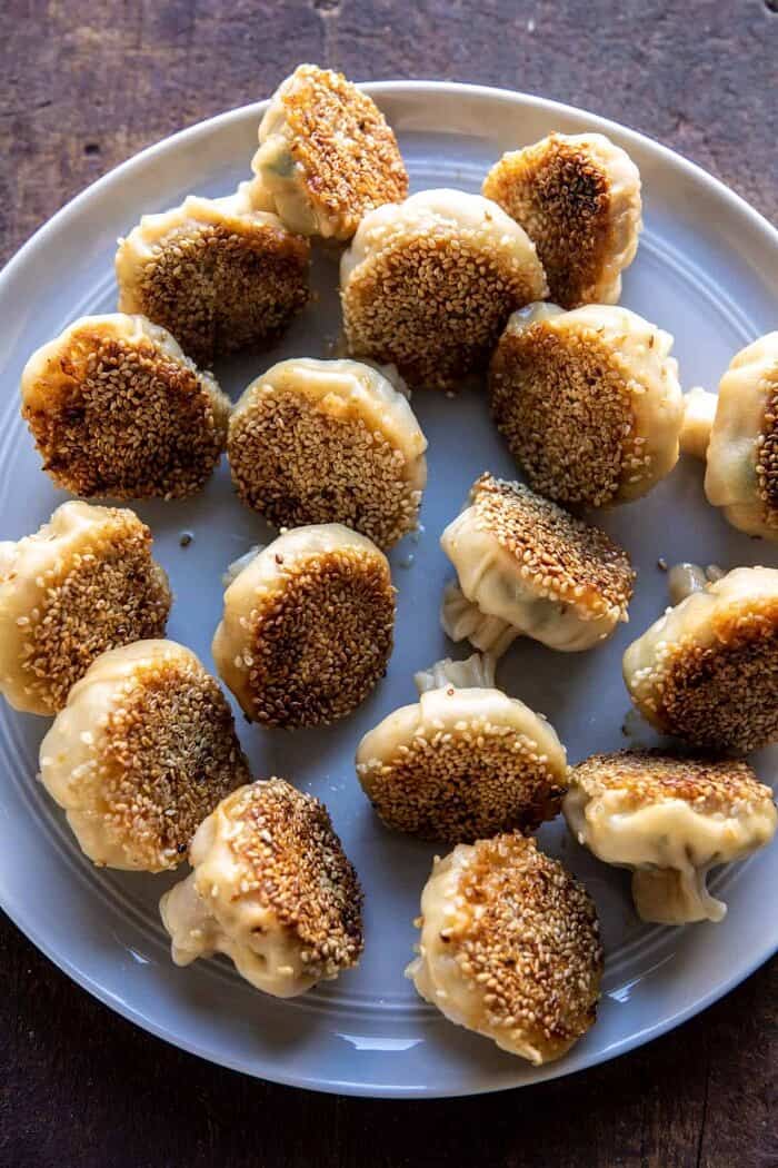 Sesame Chicken Dumplings in Spicy Broth with Garlic Crisps | halfbakedharvest.com overhead photo of Sesame Chicken Dumplings after cooking