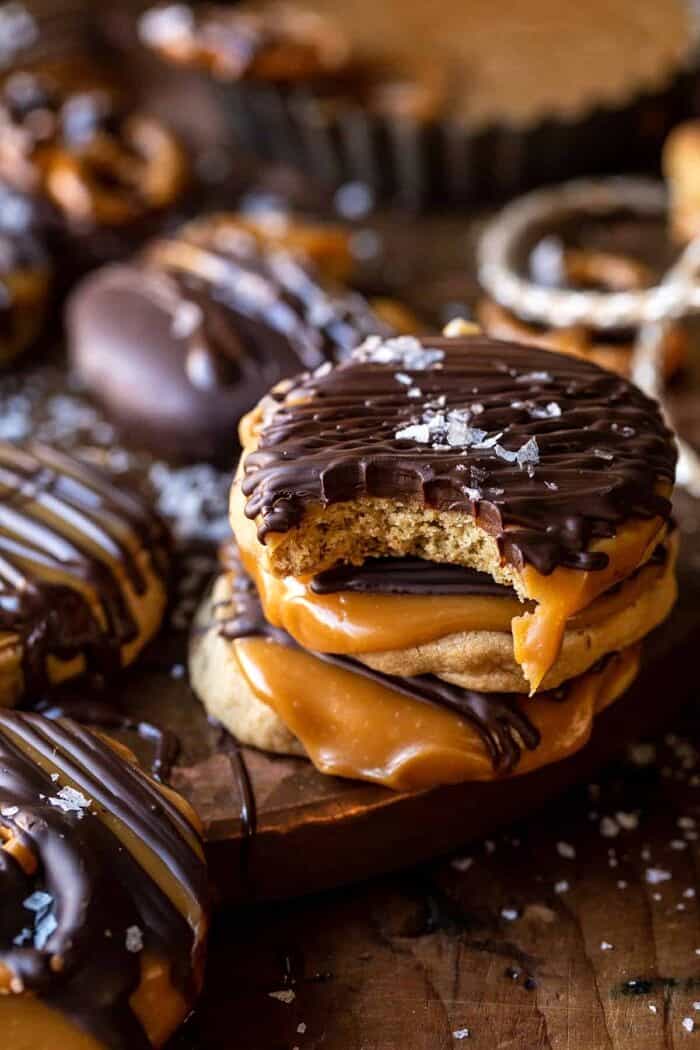 Slice n’ Bake Bourbon Caramel Pretzel Cookies | halfbakedharvest.com side angled photo of Slice n’ Bake Bourbon Caramel Pretzel Cookies with a bite taken out of cookie