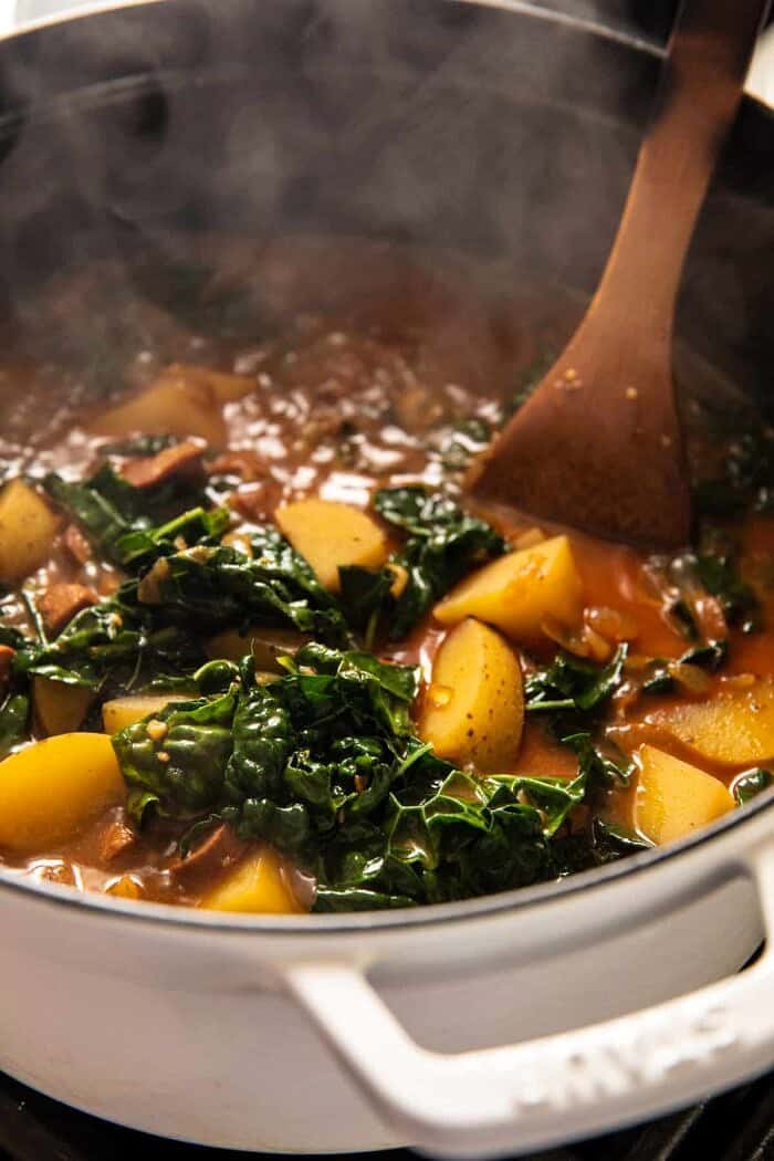 Smoky Potato and Kale Soup | halfbakedharvest.com prep photo of soup cooking in pot