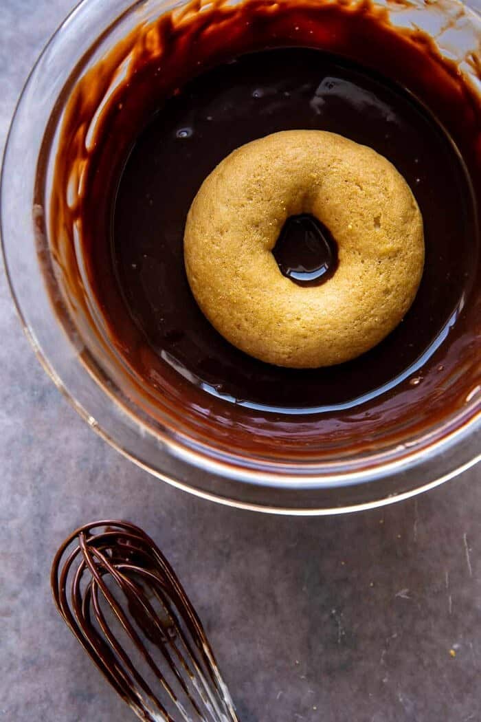 Baked Hot Chocolate Doughnuts | halfbakedharvest.com prep photo of dipping doughnuts in glaze