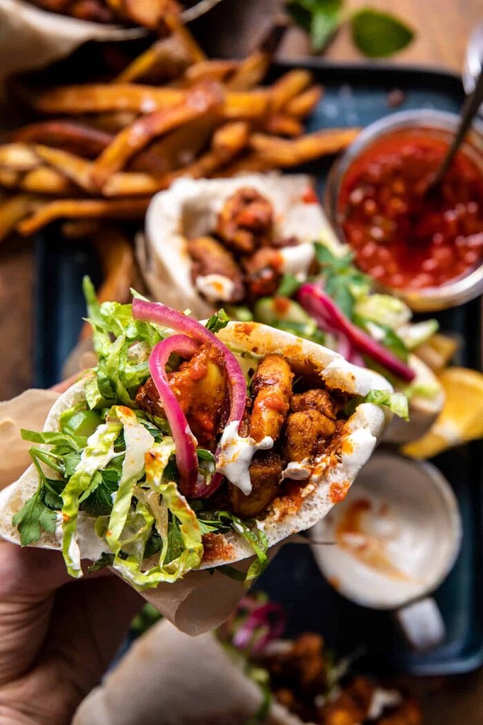 overhead photo of Roasted Turmeric Chicken Pita in hand 