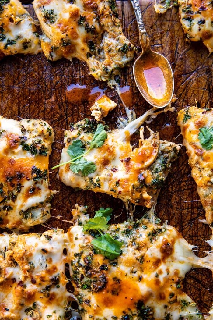 Sheet Pan Buffalo Chicken Pizza with bite take out of pizza