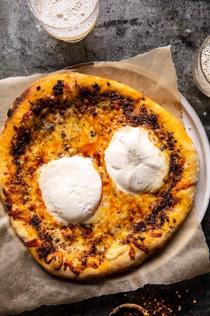 over head of Burrata Pizza before adding the salad