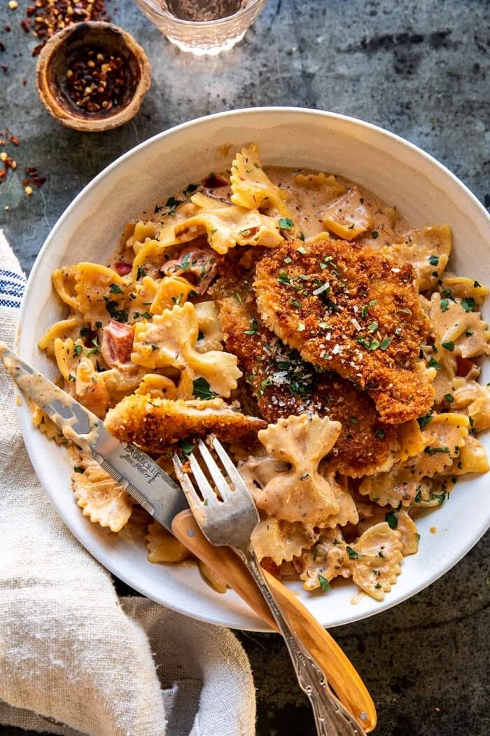 Southern Style Creamy Parmesan Chicken Pasta | halfbakedharvest.com overhead photo of Southern Style Creamy Parmesan Chicken Pasta with fork and knife in bowl