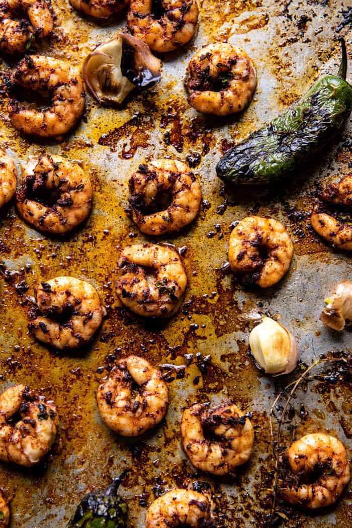 Sheet Pan Jalapeño Pineapple Shrimp Tacos with Cilantro Garlic Sauce | halfbakedharvest.com shrimp on baking sheet after baking