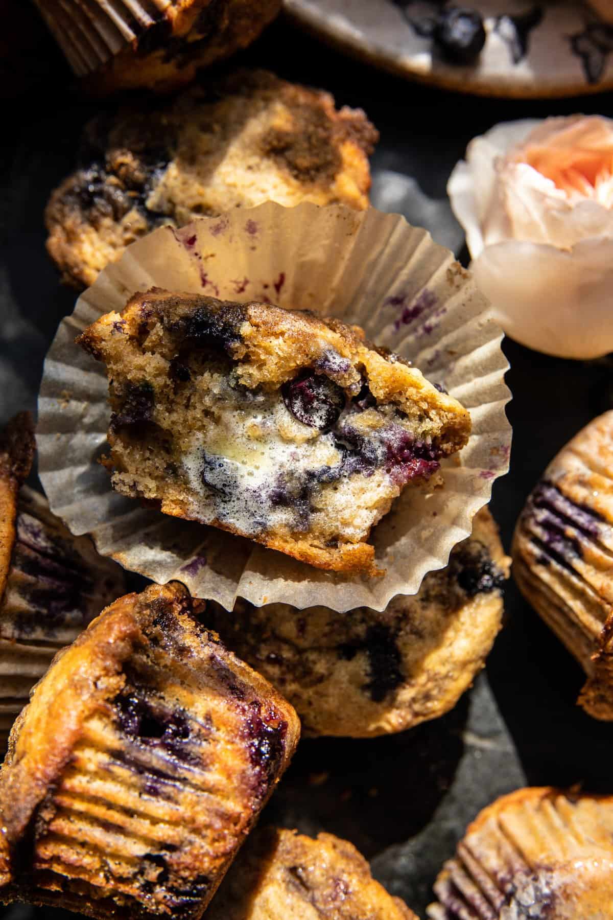 close up photo of muffin broken in half with melted butter