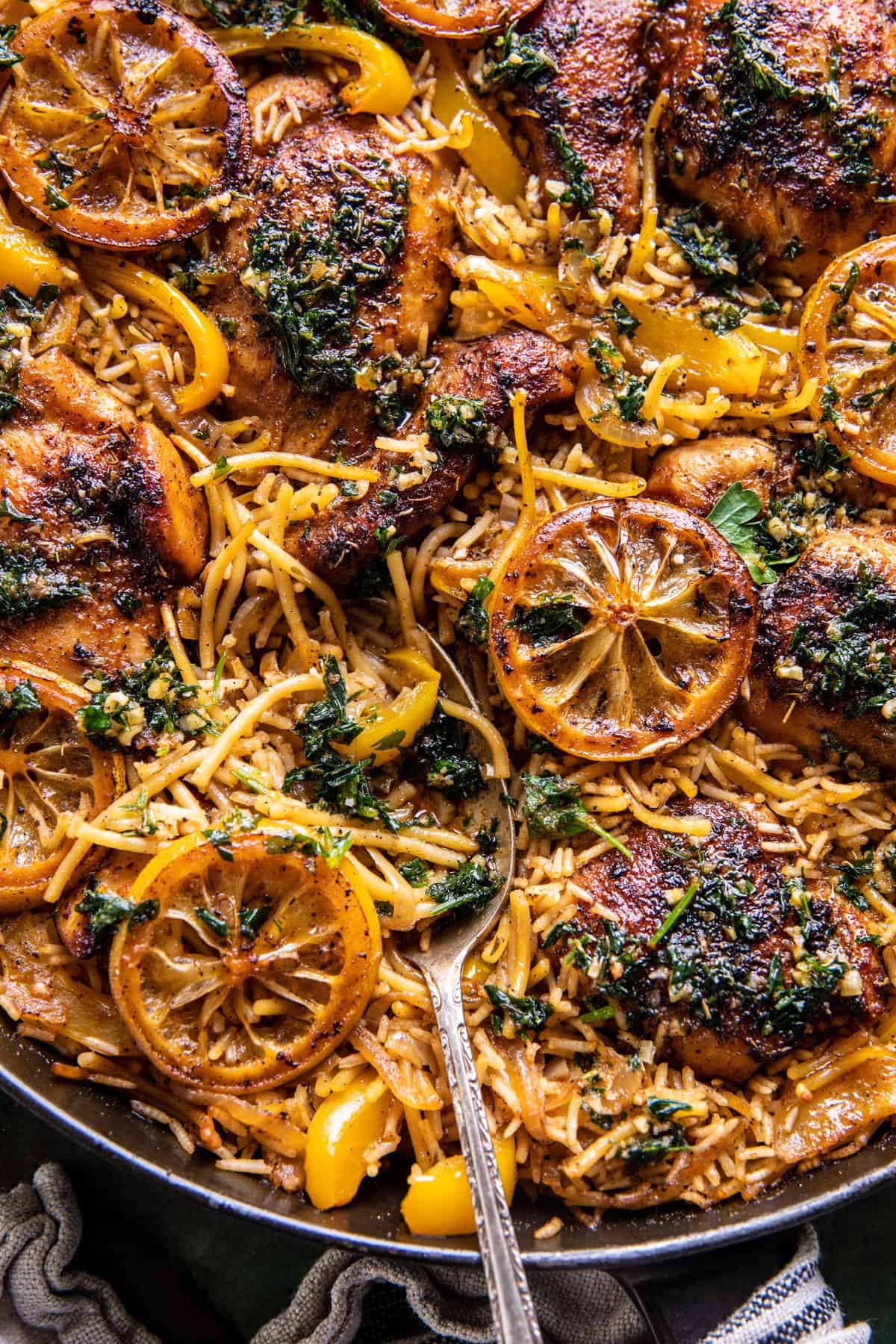 chicken and rice in skillet with spoon 