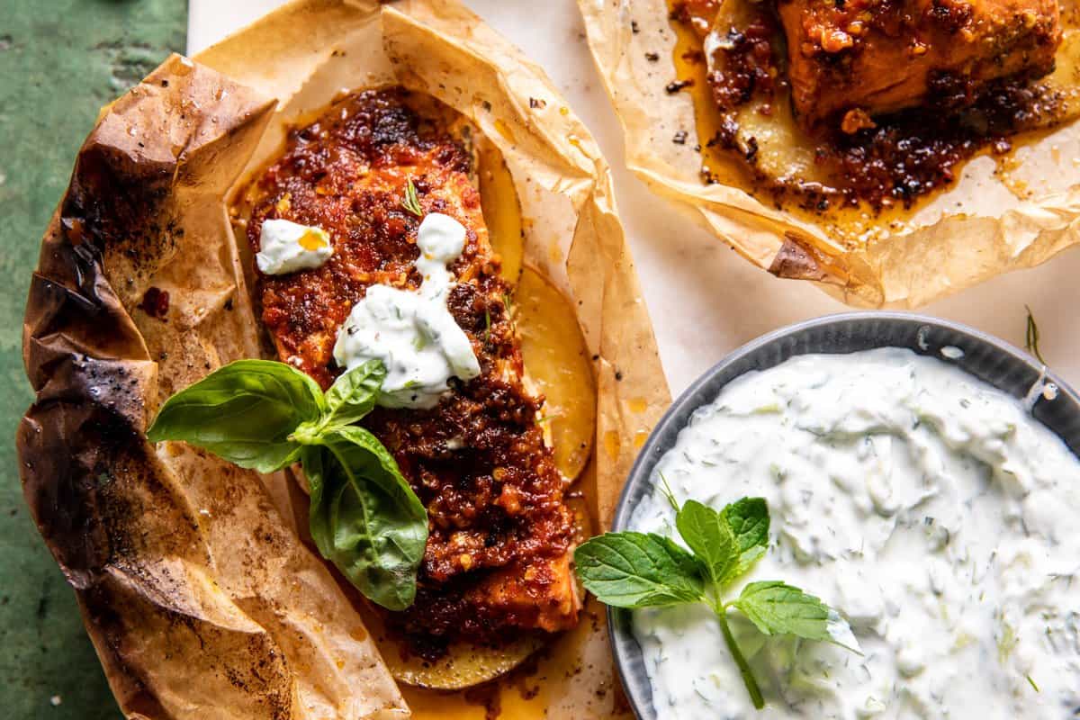 overhead photo of salmon with roasted red pepper sauce and yogurt on the side 