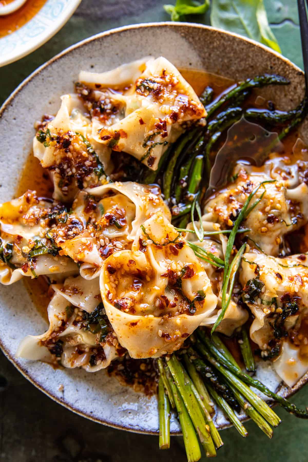 Quick Wontons in Chili Oil with Asparagus in a bowl, zoomed in photo of bowl 