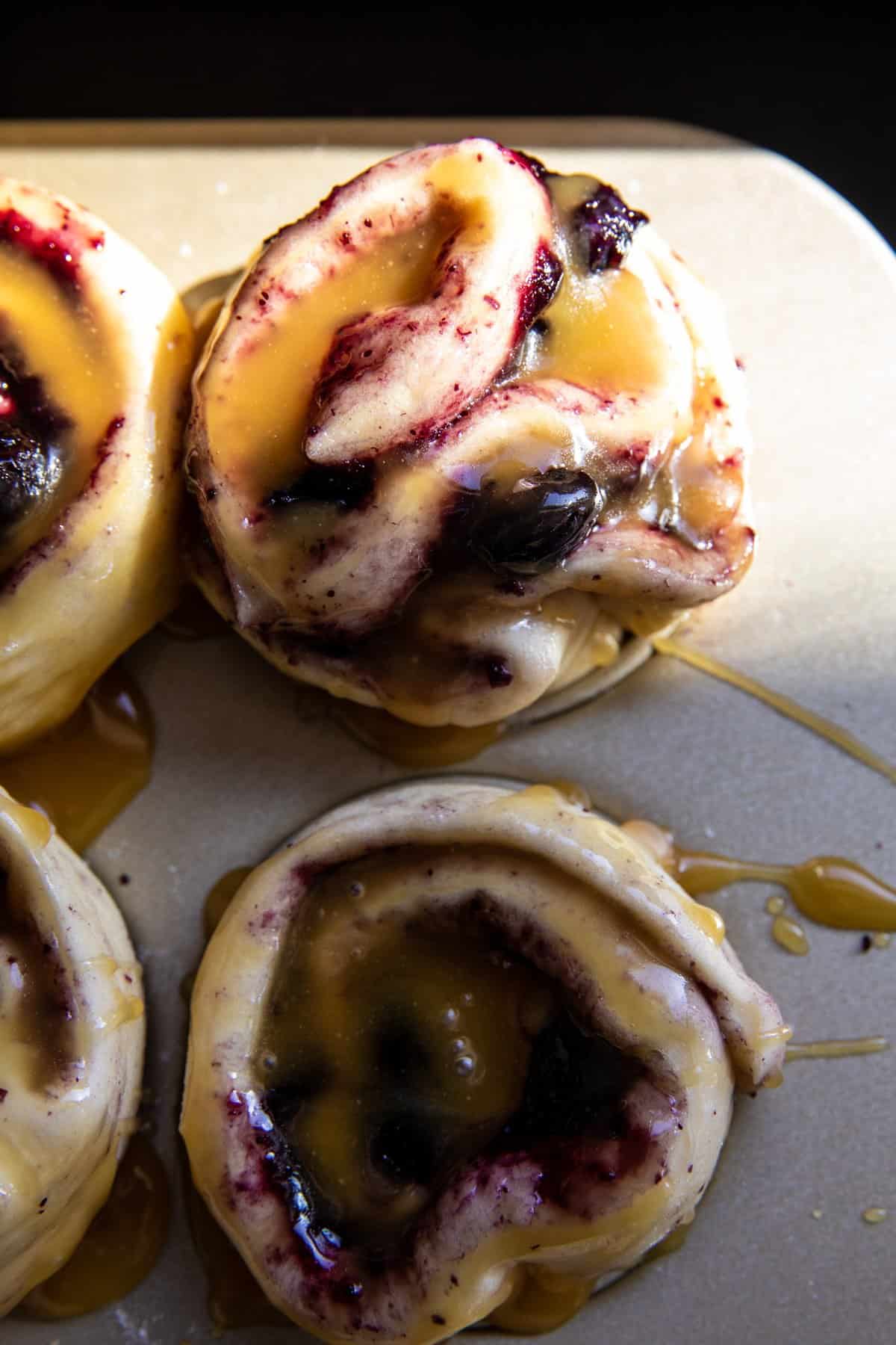 rolls before baking with honey glaze on top