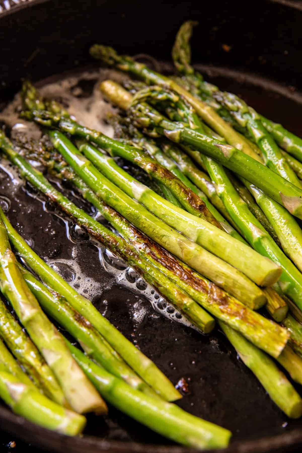asparagus cooking in skillet