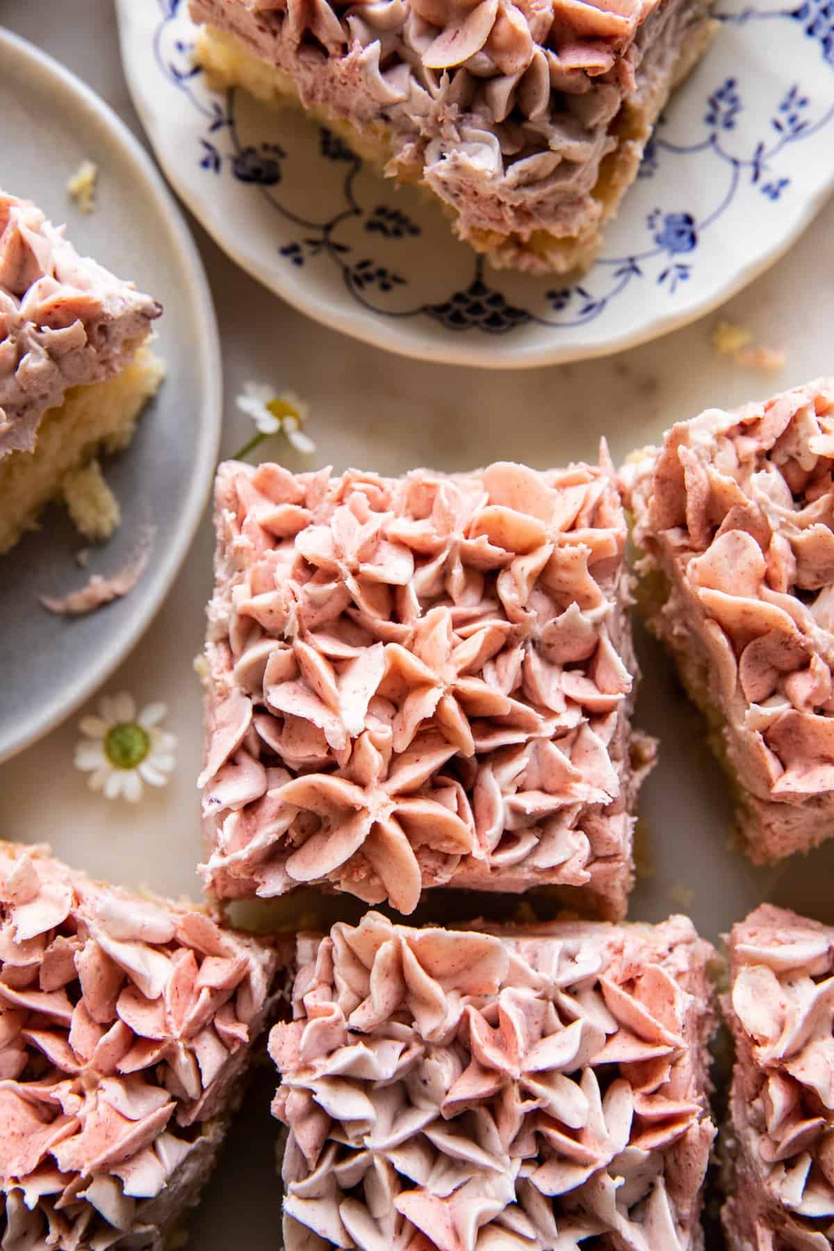 close up overhead photo of lemon cake with square slices cut