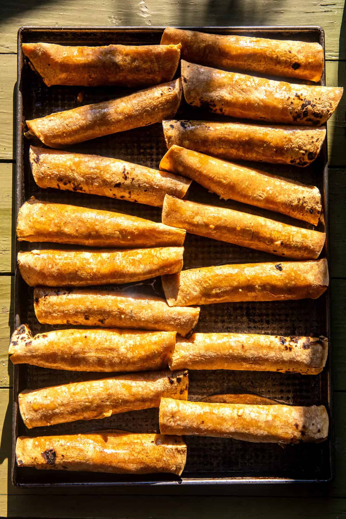 Sheet-pan Green Chile Chicken Taquitos | halfbakedharvest.com